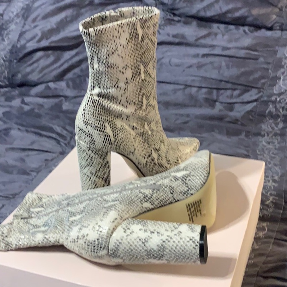 Snakeskin boots that have never been worn.